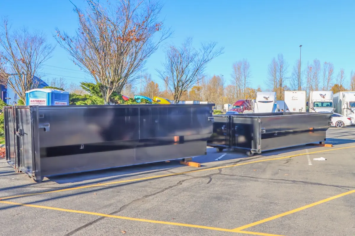 Professional dumpster rental service with roll-off container on residential driveway in Meadow Lakes